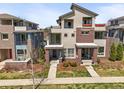 Contemporary townhome featuring brick accents and a landscaped front yard at 4535 W 50Th Ave, Denver, CO 80212