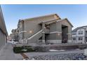 Exterior view of a townhome building with landscaping and a walkway at 4538 Copeland Loop # 202, Highlands Ranch, CO 80126