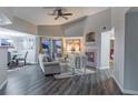 Living room with fireplace, hardwood floors, and access to a balcony at 4538 Copeland Loop # 202, Highlands Ranch, CO 80126