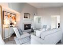 Living room featuring a fireplace, comfortable seating, and large artwork at 4538 Copeland Loop # 202, Highlands Ranch, CO 80126