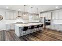Modern kitchen with a large center island, stainless steel appliances, and sleek cabinetry at 6679 Kenzie Cir, Castle Pines, CO 80108