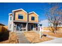 Charming two-story duplex featuring light wood and grey facade and inviting front steps on a sunny day at 4341 N Columbine St, Denver, CO 80216