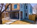 Two-story duplex featuring gray siding and wood accents at 4341 N Columbine St, Denver, CO 80216