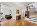 Bright entryway with hardwood floors, an elegant staircase, and views into the living room at 1433 E 7Th Ave, Denver, CO 80218