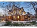 Brick home exterior at dusk, beautifully landscaped yard with snow at 1433 E 7Th Ave, Denver, CO 80218