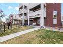 Modern townhouses feature brick facade, balconies, and a quaint porch swing at 1733 Irving St # 101, Denver, CO 80204