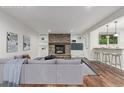 Bright living room with a cozy fireplace, built-in shelving, and a modern, comfortable design at 5890 W Quarles Dr, Littleton, CO 80128