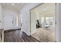 Bright foyer with dark wood floors leading to a comfortable living space at 10440 Olathe, Commerce City, CO 80022
