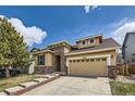 Inviting two-story home showcasing a brick and siding exterior with a two-car garage at 10440 Olathe, Commerce City, CO 80022