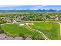 Scenic aerial view of the neighborhood park with walking paths, playground, and mountain backdrop at 10389 W Fair Ave # E, Littleton, CO 80127