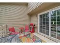 Comfortable patio area featuring a grill, outdoor seating, and sliding glass doors for easy access at 10389 W Fair Ave # E, Littleton, CO 80127