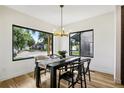 Dining area featuring a modern light fixture and a large window offering plenty of light at 4101 S Lincoln St, Englewood, CO 80113