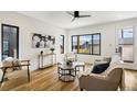 Bright living room featuring hardwood floors, modern furnishings and large window for natural light at 4101 S Lincoln St, Englewood, CO 80113