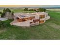 Expansive aerial view of the property showcasing a modern design, wooden pergola, outdoor seating, and surrounding landscape at 1764 Mesa Ridge Ln, Castle Rock, CO 80108