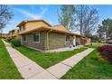 Exterior view of home with green grass and sidewalks at 12458 E Kansas Pl, Aurora, CO 80012