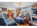 Cozy living room featuring a fireplace, hardwood floors, and bright natural light at 12458 E Kansas Pl, Aurora, CO 80012