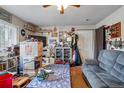 Cozy living room with ceiling fan and door to exterior at 12458 E Kansas Pl, Aurora, CO 80012