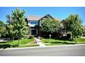 Charming home with well-kept lawn, lush landscaping, mature trees, and inviting curb appeal at 15857 E Aberdeen Ave, Centennial, CO 80016