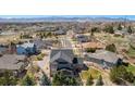 Stunning aerial view of home in a peaceful neighborhood with mountain backdrop at 12518 W 77Th Pl, Arvada, CO 80005