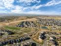 Expansive aerial view showing the home's neighborhood surrounded by open spaces and community amenities at 90 Moonrise Ct, Erie, CO 80516