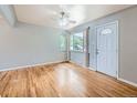 A bright living room with beautiful hardwood floors, a ceiling fan, and ample natural light at 1856 S Steele St, Denver, CO 80210