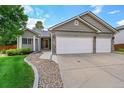 Lovely single-story home with a three-car garage, stone accents, and manicured landscaping at 2205 Santa Fe Dr, Longmont, CO 80504