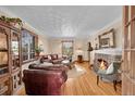 Inviting living room with hardwood floors, a stone fireplace, and comfortable leather seating at 3070 Colorado Blvd, Denver, CO 80207