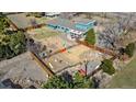 Aerial view of the home with backyard playground, shed, and lush green surroundings at 7400 W Quincy Ave, Littleton, CO 80123