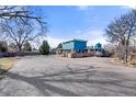 Charming single-story house with a well-maintained exterior and ample parking space at 7400 W Quincy Ave, Littleton, CO 80123