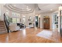 Bright living room with hardwood flooring, fireplace, and staircase access at 5170 Pinyon Jay Rd, Parker, CO 80134