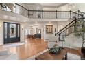 Open-concept living area with hardwood floors, staircase, and view of the dining area at 5170 Pinyon Jay Rd, Parker, CO 80134