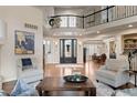 Spacious living room with hardwood floors, high ceilings, and abundant natural light at 5170 Pinyon Jay Rd, Parker, CO 80134