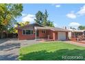 Beautiful one story home with an attached garage, a spacious lawn, and a comfortable walkway at 4585 S Elati St, Englewood, CO 80110