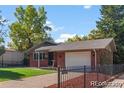 Lovely single Gathering home with a manicured lawn, attached garage, and classic brick exterior at 4585 S Elati St, Englewood, CO 80110