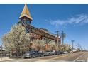 Multi-story building featuring attached pedestrian bridge and a combination of metal and brick facade at 2715 Blake St # 2, Denver, CO 80205
