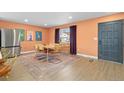 Spacious dining room with hardwood floors, a modern rug, and decorative artwork at 6426 Zang Ct, Arvada, CO 80004