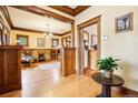 Bright living room featuring wood trim, hardwood floors, and a classic brick fireplace at 4253 Hooker St, Denver, CO 80211