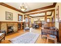 Open-concept living area with hardwood floors, brick fireplace, and natural light at 4253 Hooker St, Denver, CO 80211