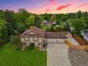 Two-story home boasts a spacious driveway, charming shed, lush lawn, and an attached two-car garage at 5954 W Leawood Dr, Littleton, CO 80123