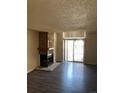 Inviting living room with a stone fireplace, sliding glass doors, and vinyl flooring at 931 S Zeno Way # 106, Aurora, CO 80017