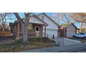 Front view of charming ranch home with a carport at 6567 Pierson St, Arvada, CO 80004