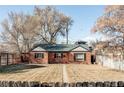 Quaint brick home with mature trees, a charming pergola, and a well-maintained front yard at 3641 N Cook St, Denver, CO 80205