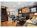 Charming living area with exposed brick, fireplace, hardwood floors and view into the adjacent dining area at 3233 W 29Th Ave, Denver, CO 80211