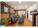 Inviting living room showcasing exposed brick, hardwood floors, and contemporary furnishings for a stylish aesthetic at 3233 W 29Th Ave, Denver, CO 80211