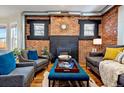 Cozy living room with brick fireplace, modern furniture, and ample natural light at 3233 W 29Th Ave, Denver, CO 80211