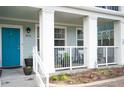 Inviting front porch featuring a bright blue door and cozy seating area at 7472 E 28Th Ave, Denver, CO 80238