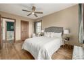 Bedroom showcasing a queen bed, hardwood floors, a ceiling fan, and natural light from the window at 1138 E 14Th Ave # 12, Denver, CO 80218