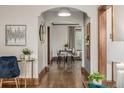 Hallway showing wood floors, arched doorways leading to living and dining areas with natural light at 1138 E 14Th Ave # 12, Denver, CO 80218