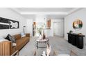 Bright living room featuring stylish furniture, a view of the kitchen, and contemporary decor at 4395 E Jewell Ave # 3, Denver, CO 80222