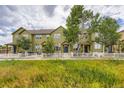 Exterior view of a multi-story home boasts a well-manicured lawn and white picket fence at 3578 Tranquility Trl, Castle Rock, CO 80109